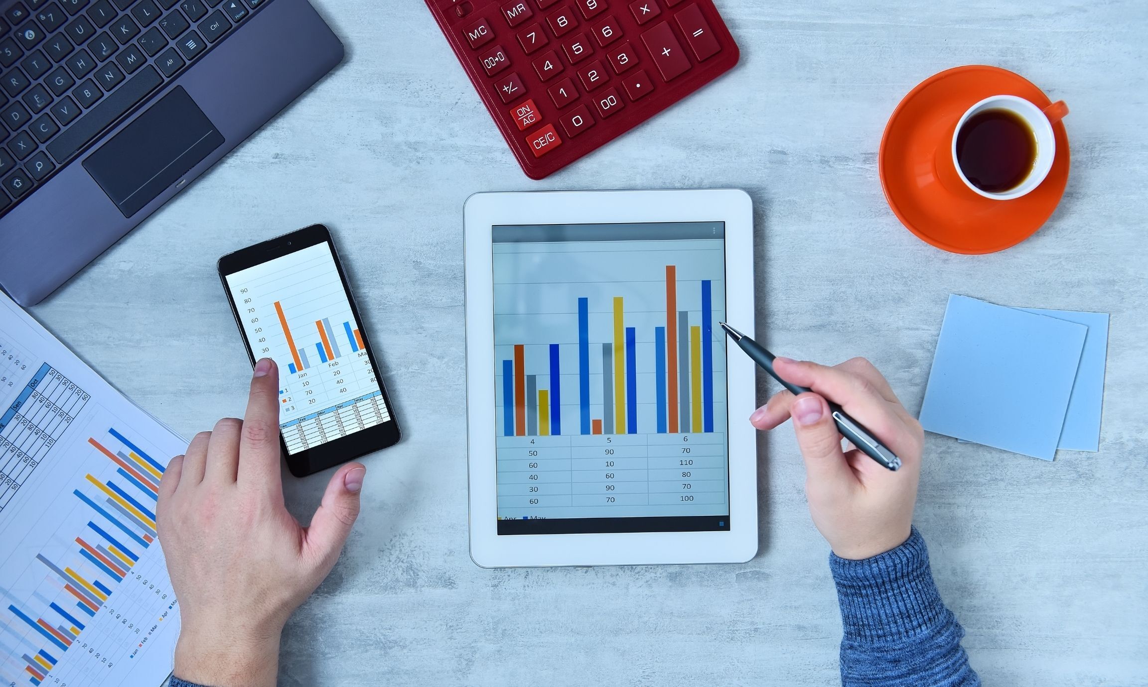 Person seeing metric dashboards on phone and tablet